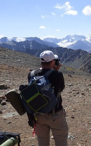 Goal Zero solar panel clipped to backpack while hiking off the grid in Kyrgyzstan, Central Asia