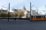 city tram going by the Parliament building